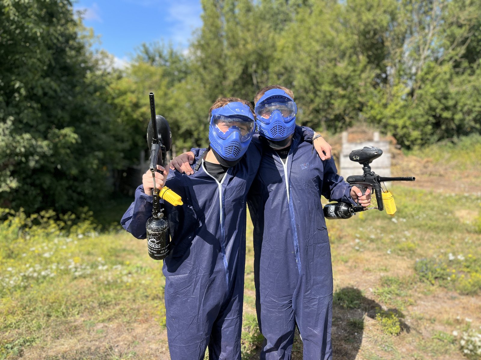 Groupe d'amis équipés pour une partie de paintball lors d'un EVG chez Team Square